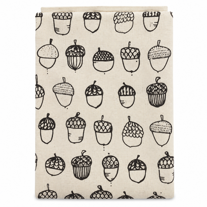 Cream tea towel with acorn design printed in brown on a white background.