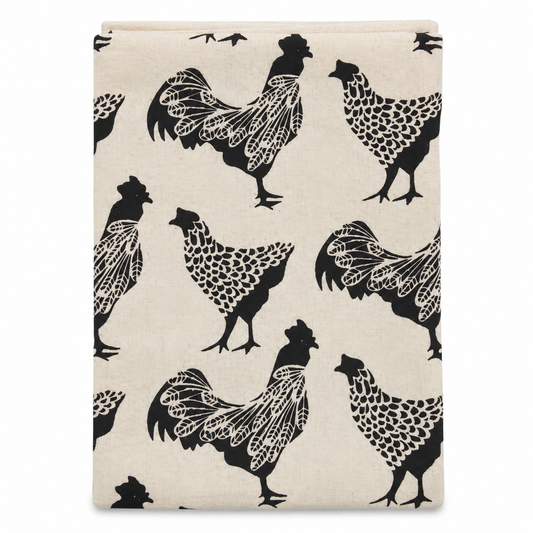 A cream colored tea towel with chicken design printed in black on a white background.