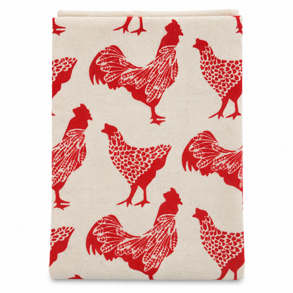 A cream colored tea towel with chicken design printed in red on a white background.