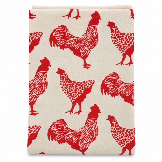 A cream colored tea towel with chicken design printed in red on a white background.