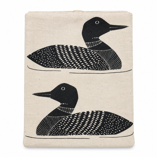 A cream colored tea towel with black loon design on a white background.