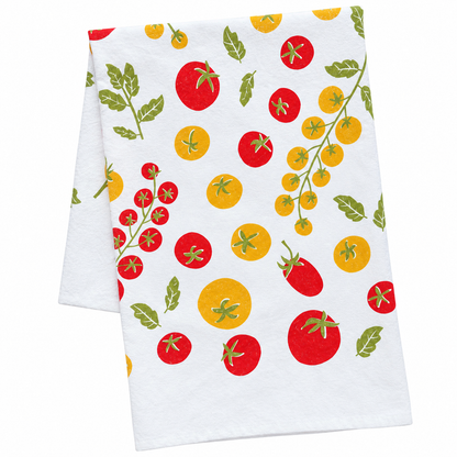 A cream colored tea towel with red and yellow tomato design on a white background.