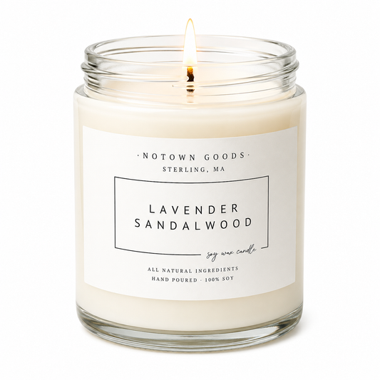 Clear jar candle with white wax and a decorative label on a white background.