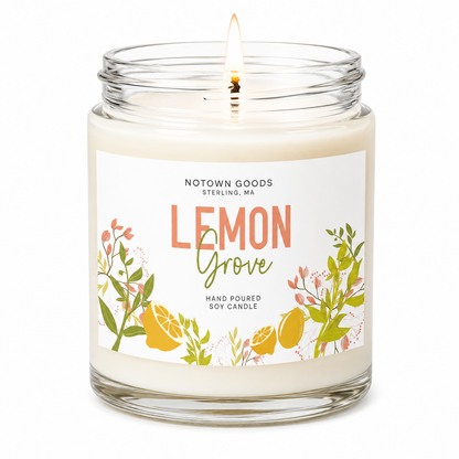 Clear jar candle with white wax and a decorative label on a white background.