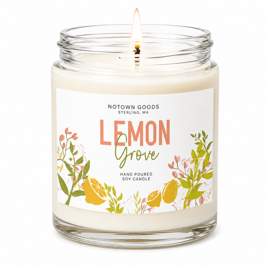 Clear jar candle with white wax and a decorative label on a white background.