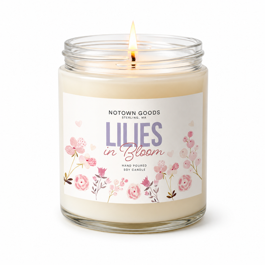 Clear jar candle with white wax and a decorative label on a white background.