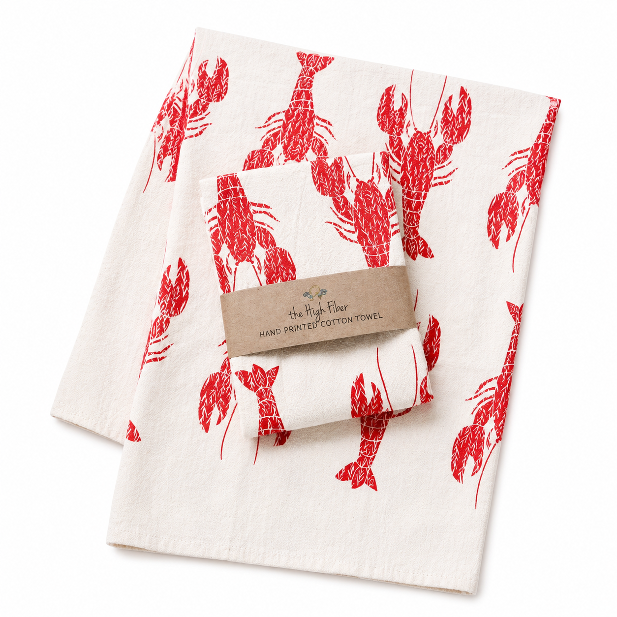 Two tea towels with red lobster print on cream colored towels on a white background.