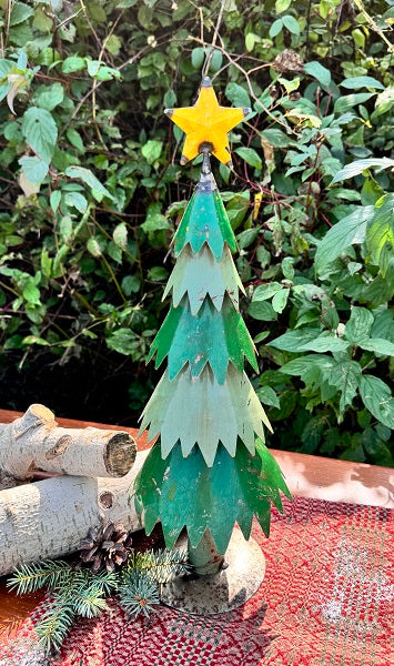 Decorative metal tree with a yellow star on a natural background