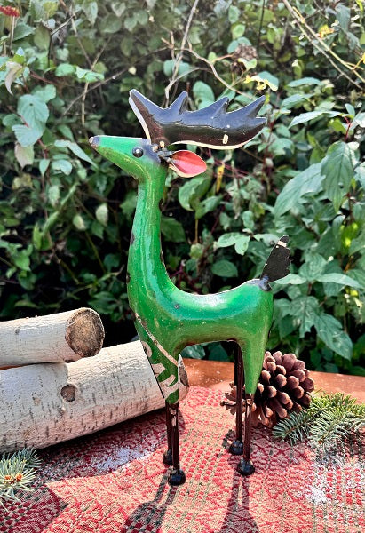 Green metal reindeer figurine on a garden table