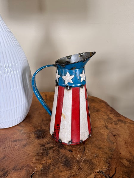 Decorative pitcher with American flag design on a wooden surface