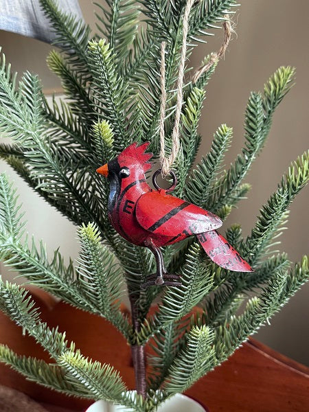 Red cardinal ornament on a green plant