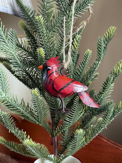 Red cardinal ornament on a green plant