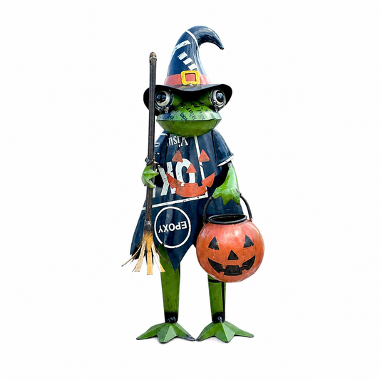 Frog statue in Halloween costume with witch hat, broom, and pumpkin bucket on a white background