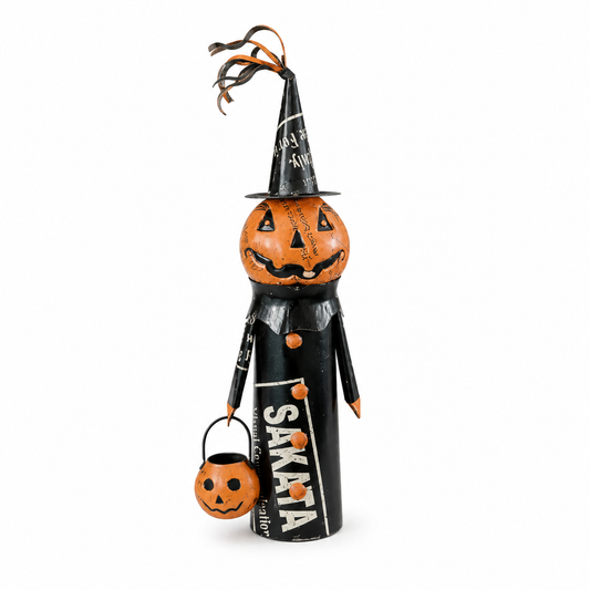 Halloween-themed decorative figure with a pumpkin head and black dress on white background.