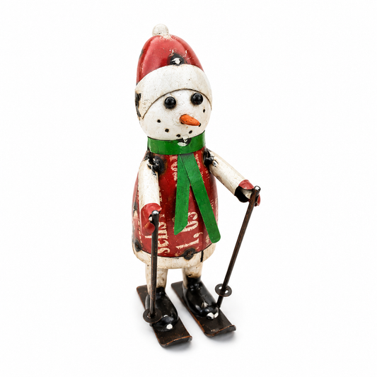 Metal snowman with a red hat, green scarf, and skis on a white background