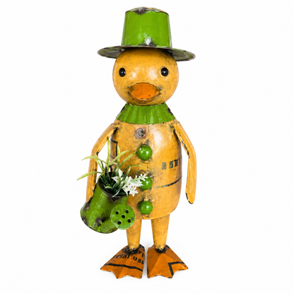 Metal duck figurine with green hat and green watering can filled with flowers on a white background.