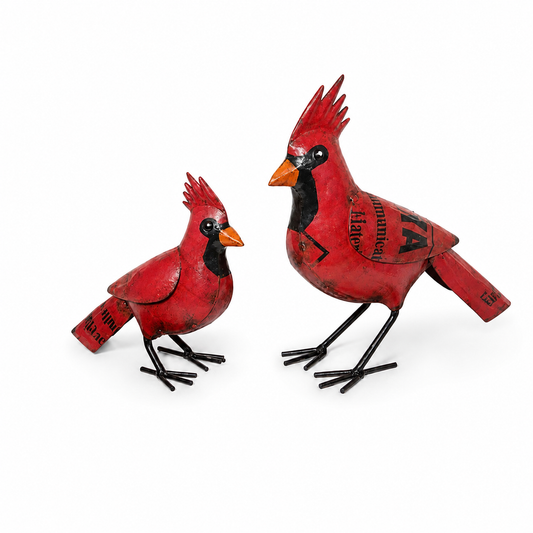 Two red cardinal bird figurines on a white background. 