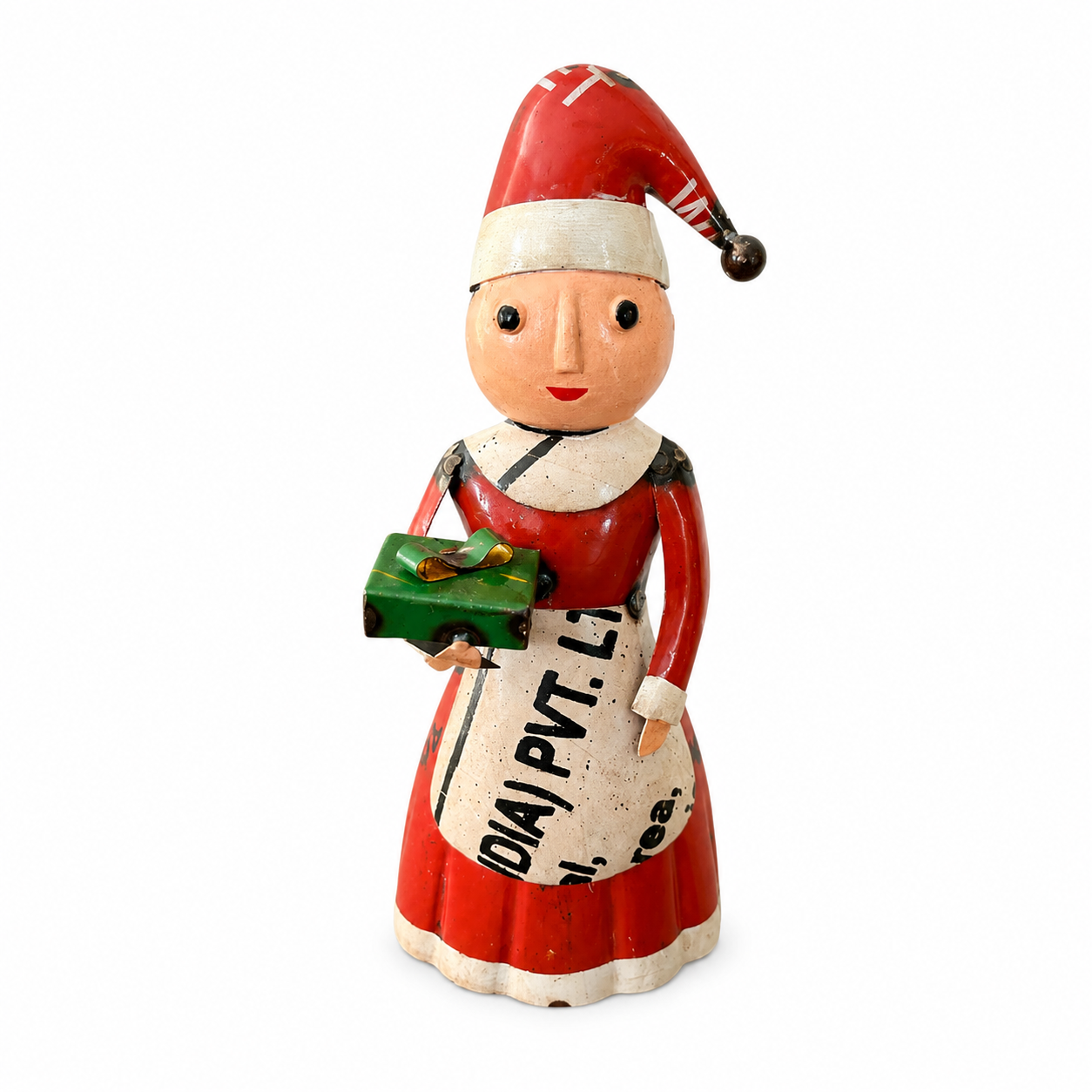 Vintage-style Christmas figure of a woman in a red dress and Santa hat holding a bag and gift.