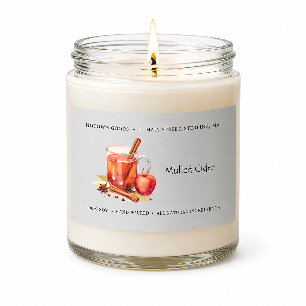 Clear jar candle with white wax and a decorative label on a white background.