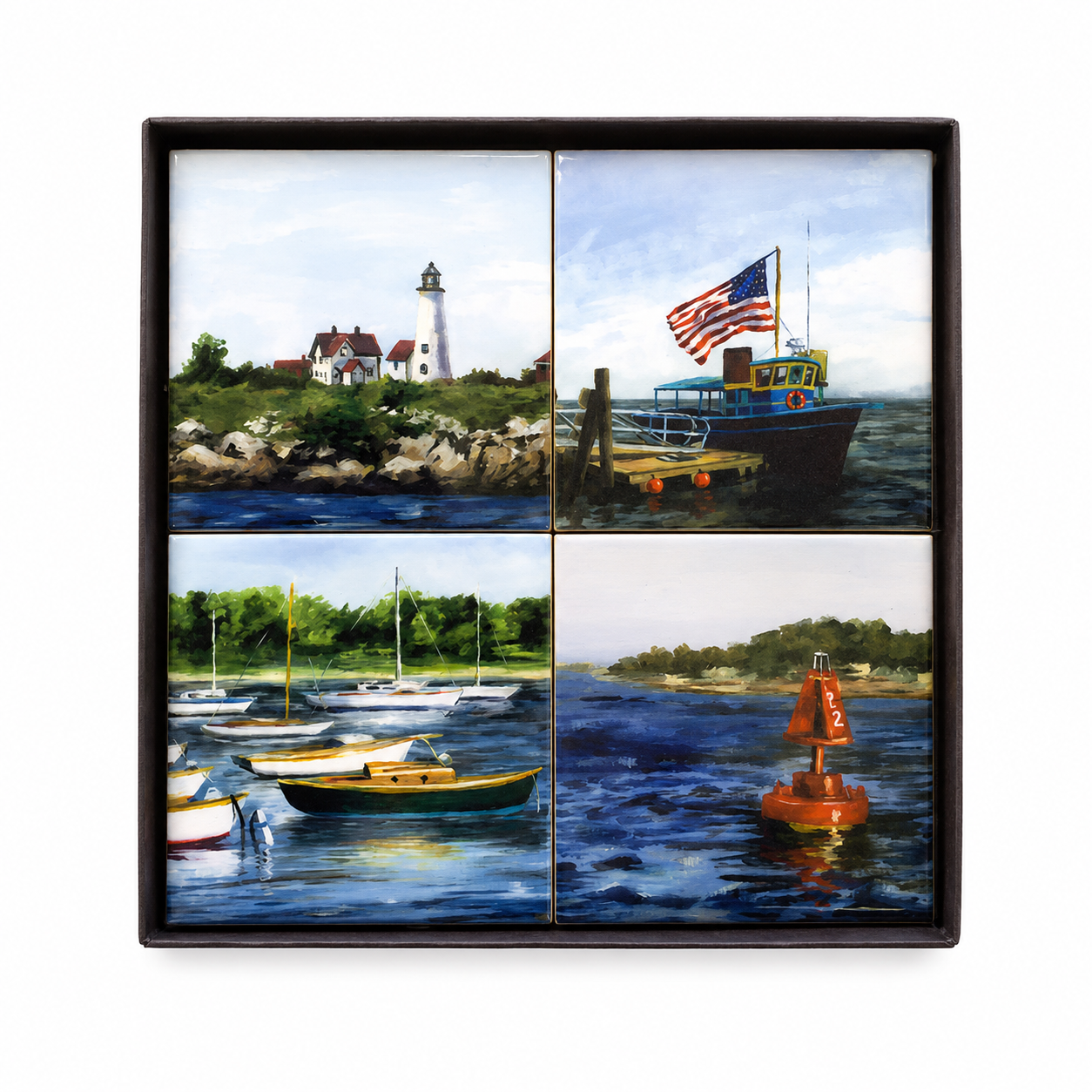 Set of 4 coasters with nautical themes presented in a gift box on a white background.