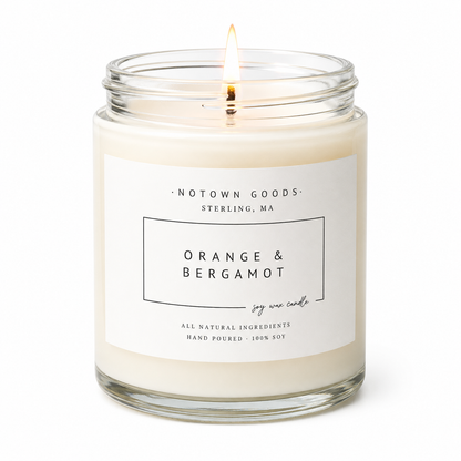 Clear jar candle with white wax and a decorative label on a white background.