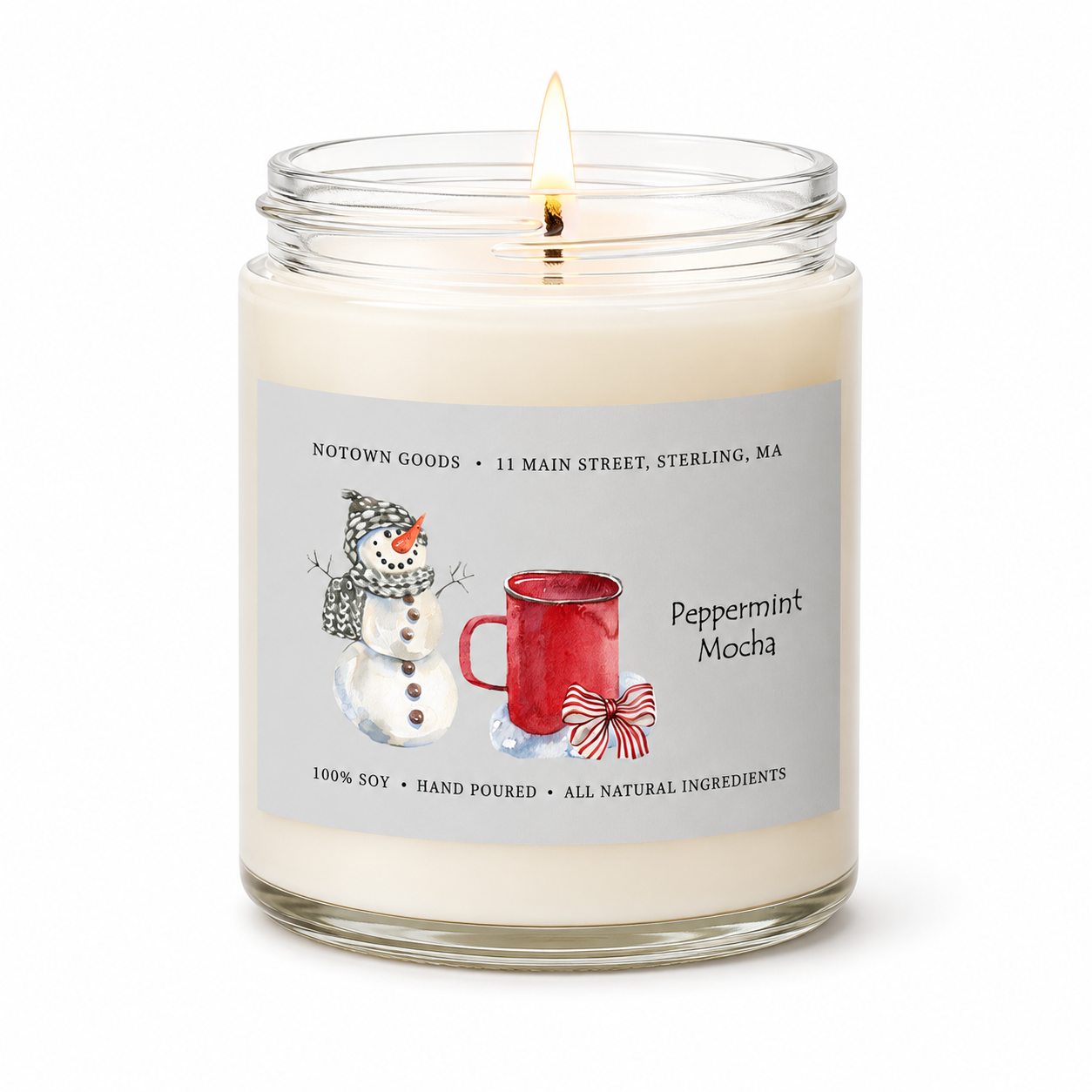 Clear jar candle with white wax and a decorative label on a white background.