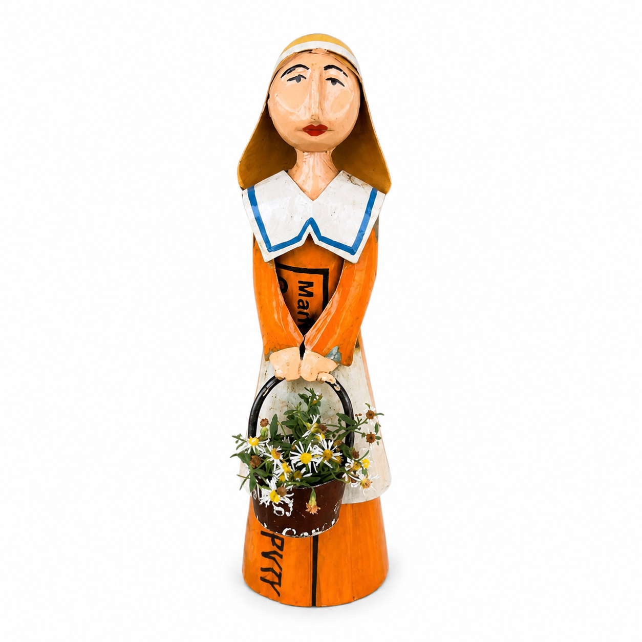 Figurine of a female pilgrim in an orange dress holding a black bucket of white flowers on a white background.