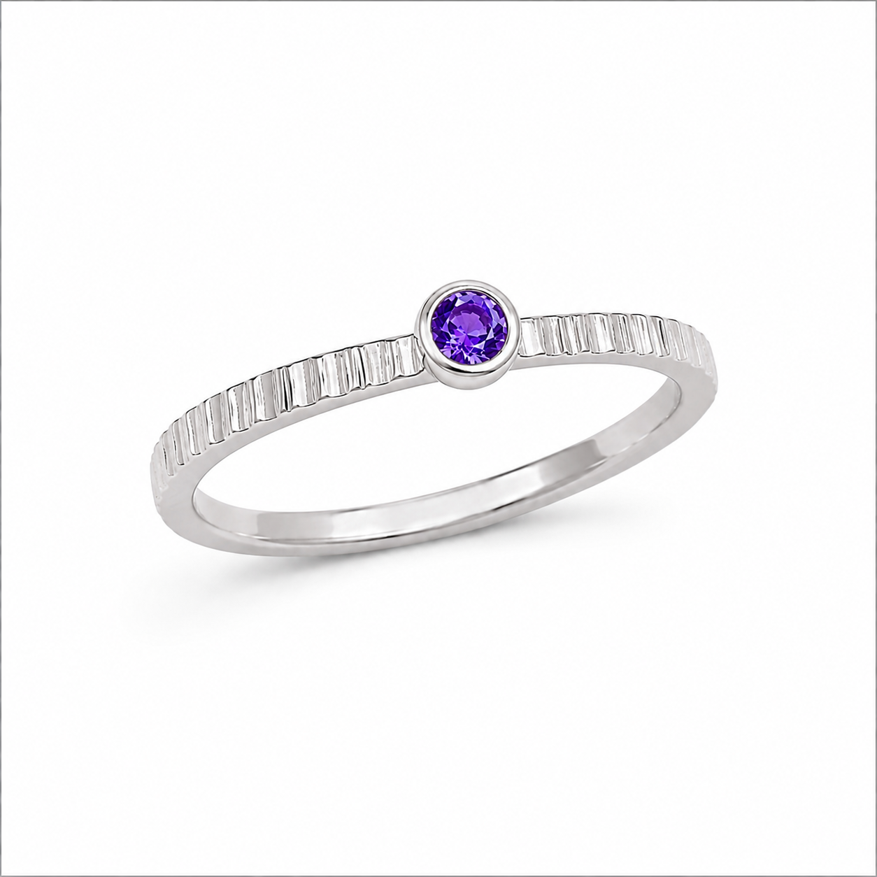 Silver ring with a purple gemstone on a white background