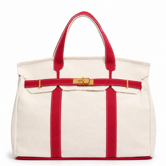 White tote bag with red straps and trim on a white background