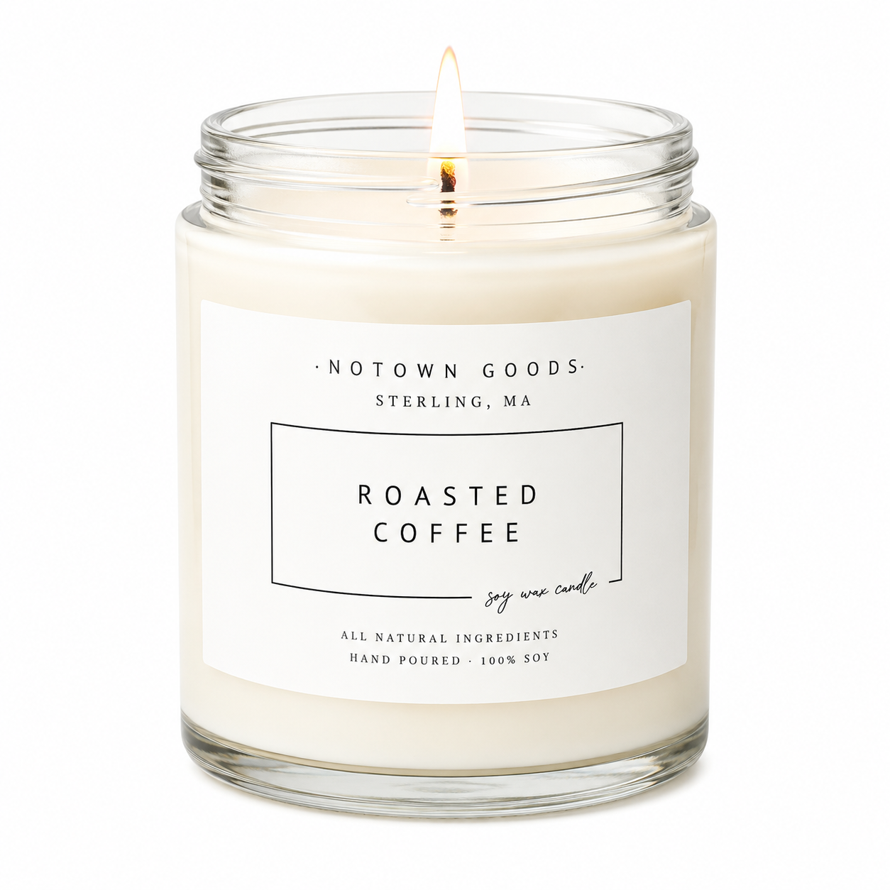 Clear jar candle with white wax and a decorative label on a white background.
