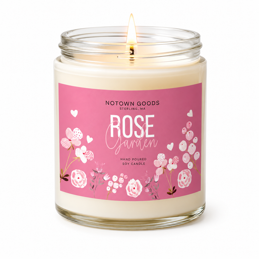 Clear jar candle with white wax and a decorative label on a white background.
