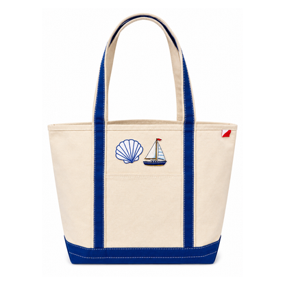 Beige tote bag with blue handles and nautical-themed embroidery on a white background