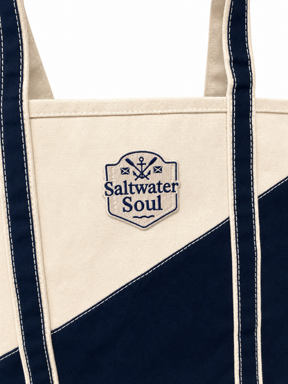 Navy and beige tote bag with 'Saltwater Soul' logo on a white background