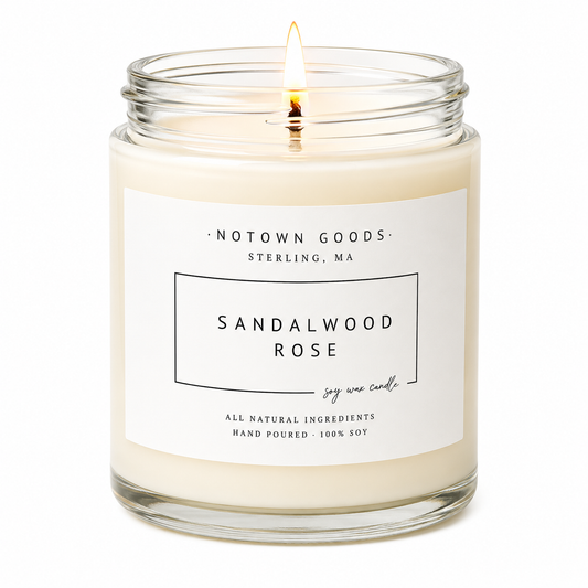 Clear jar candle with white wax and a decorative label on a white background.
