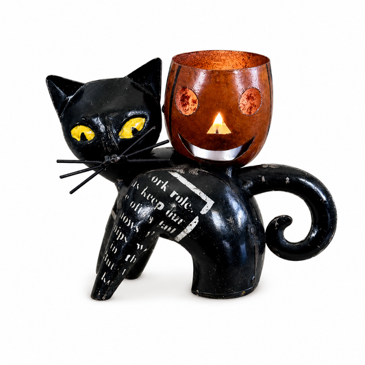 Black cat-shaped candle holder with a small orange candle inside on a white background