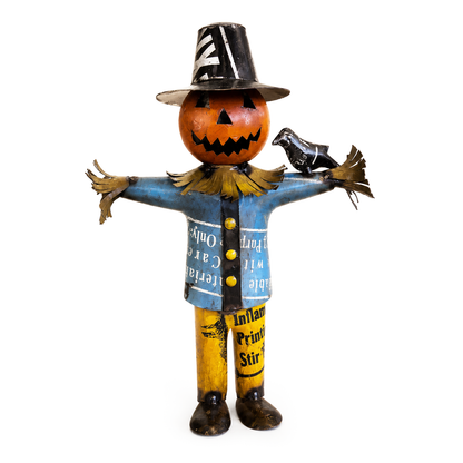 Scarecrow figurine with pumpkin head and blue shirt on a white background