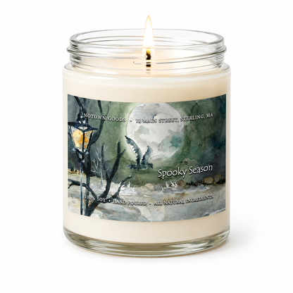 Clear jar candle with white wax and a decorative label on a white background.