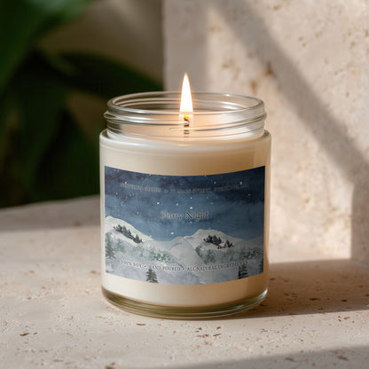 Clear jar candle with white wax and a decorative label on a blurred outdoor background.