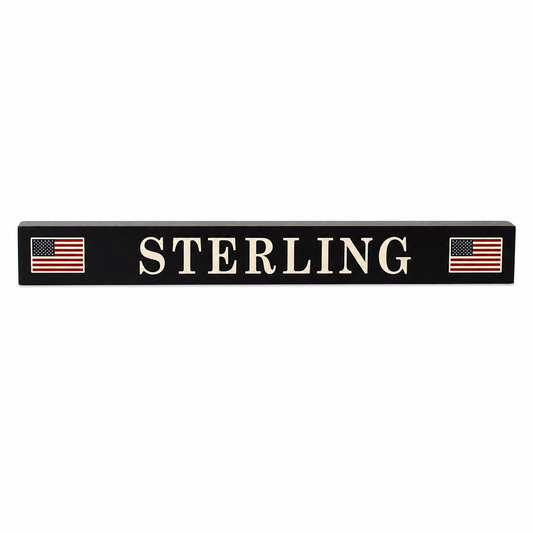 Dark navy blue sign with 'STERLING' in white letters, flanked by American flags on a white background