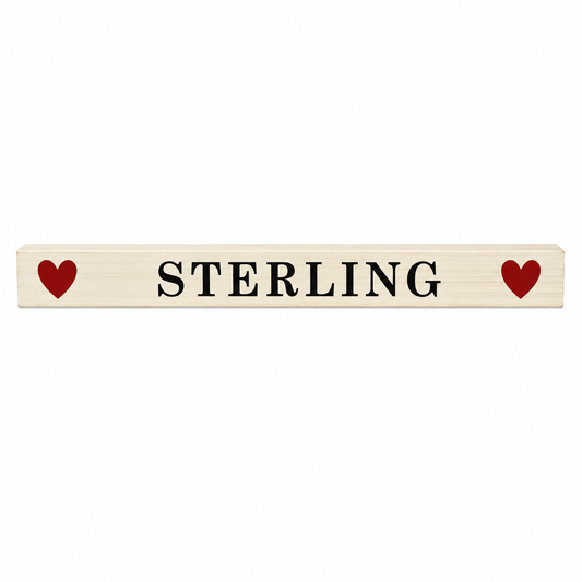 Wooden nameplate with 'STERLING' text and red hearts on a white background