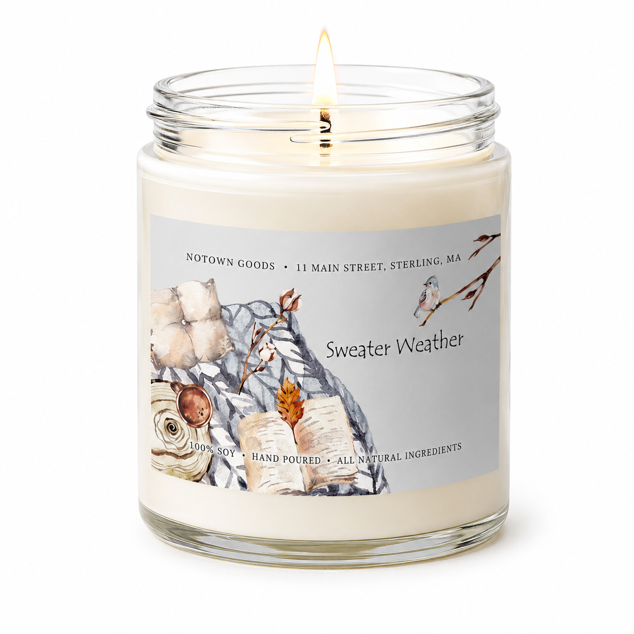Clear jar candle with white wax and a decorative label on a white background.