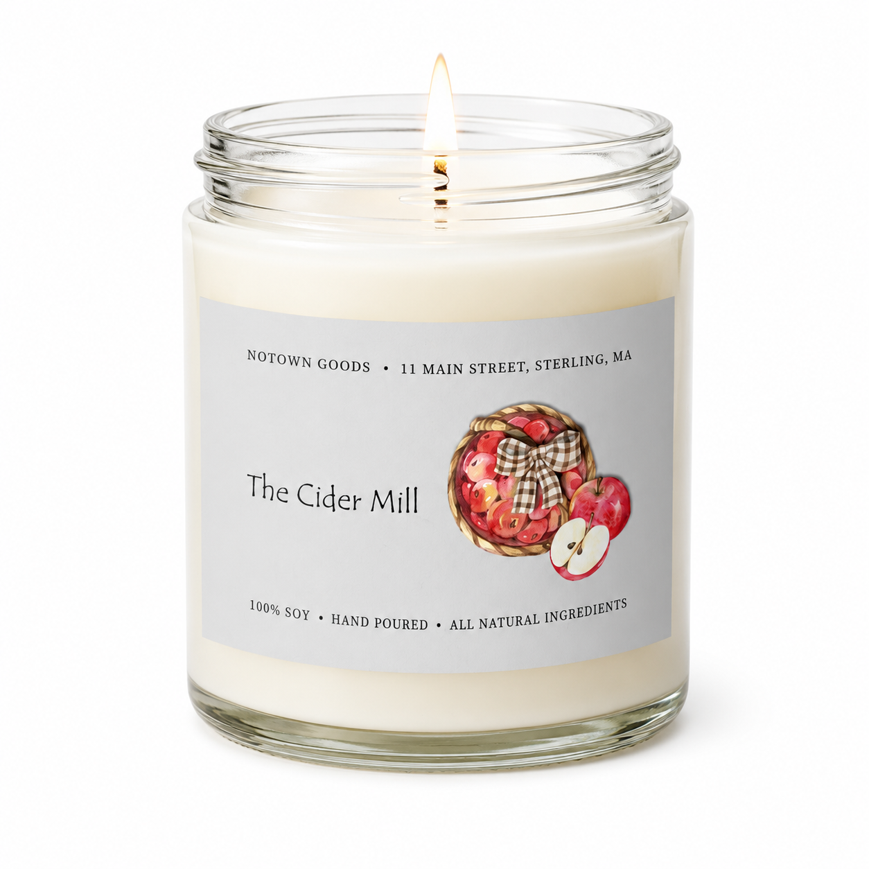 Clear jar candle with white wax and a decorative label on a white background.