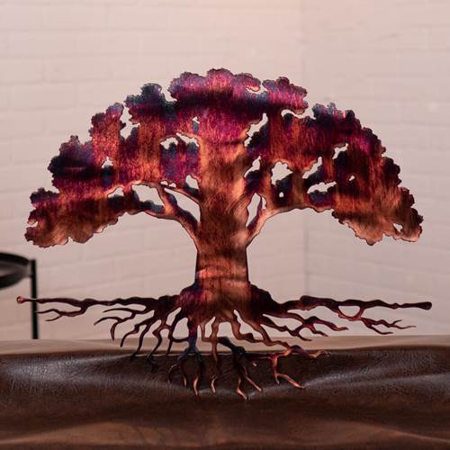 Metal tree sculpture with a warm, glowing effect on a neutral background