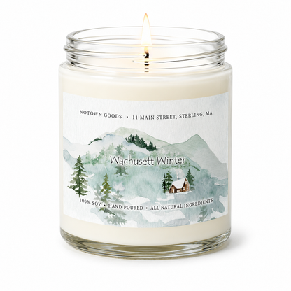 Clear jar candle with white wax and a decorative label on a white background.