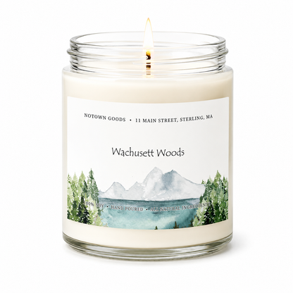 Clear jar candle with white wax and a decorative label on a white background.