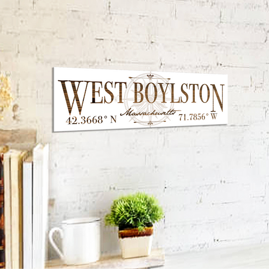 Decorative sign with 'West Boylston' text on a white brick wall background
