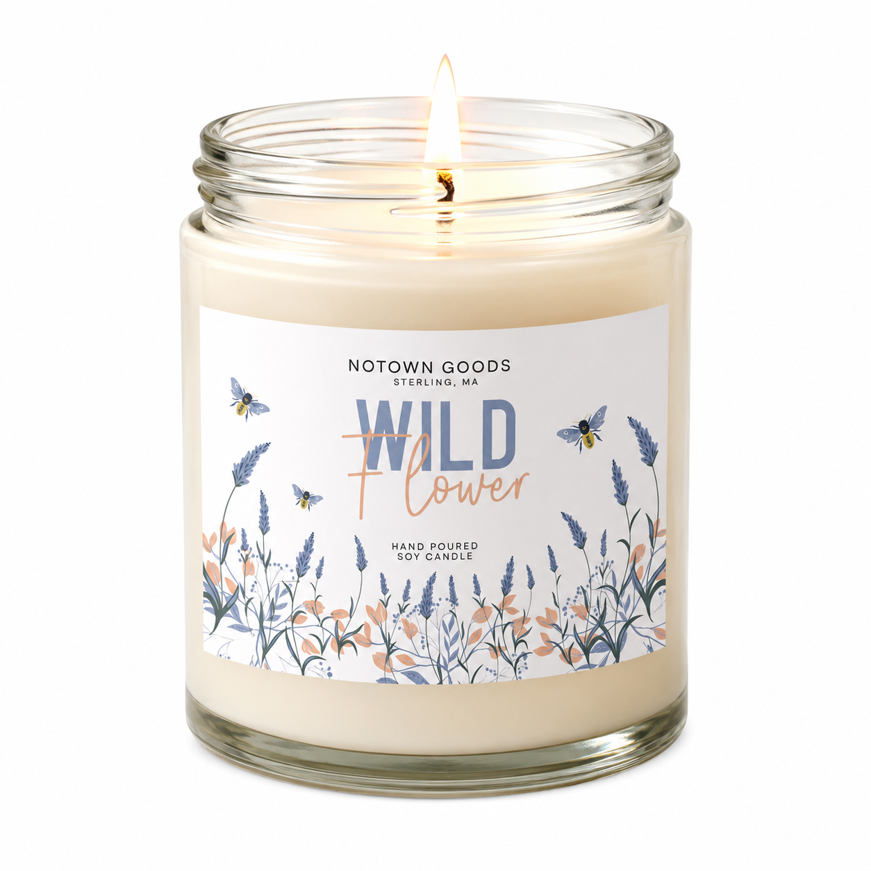 Clear jar candle with white wax and a decorative label on a white background.