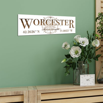 Decorative sign with 'Worcester' and coordinates on a green wall above a wooden sideboard with flowers and a clock.