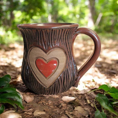 Ceramic mug with heart design in a natural setting