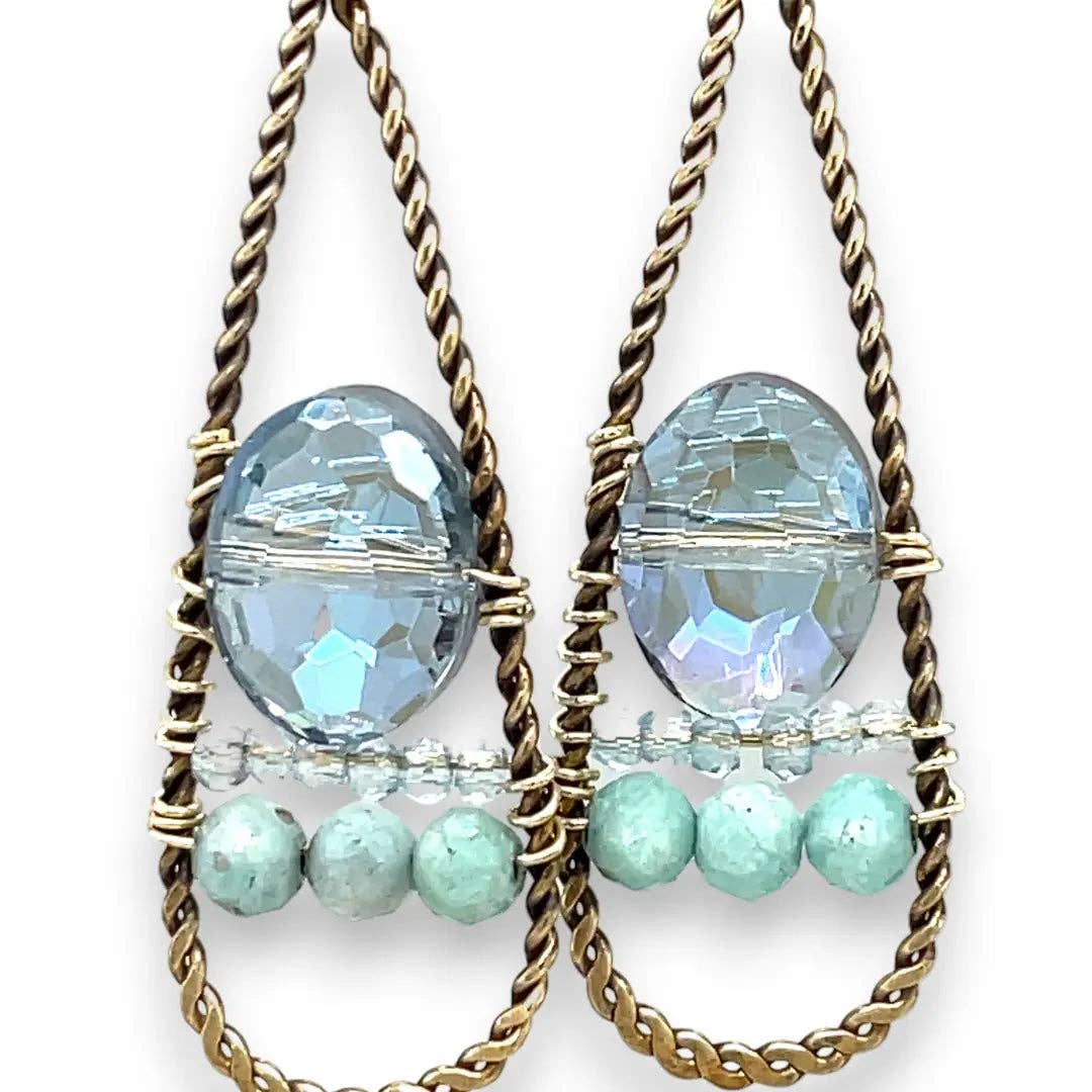 Pair of earrings with blue and green beads on a white background